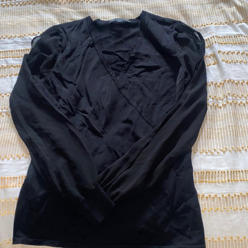 Woman’s black top. Sheer sleeves with slits
